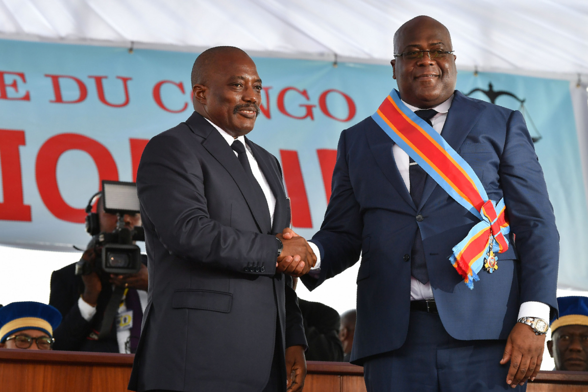 Democratic Republic of the Congo's outgoing President Joseph Kabila (L) shakes hands with newly inaugurated President Felix Tshisekedi on Jan. 24, 2019 after he was sworn-in in Kinshasa. (Tony Karumba/AFP/Getty Images)