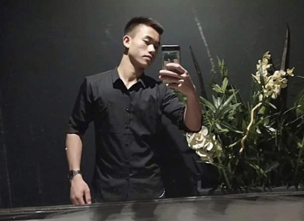 Nguyen Dinh Luong, 20, poses for a selfie 