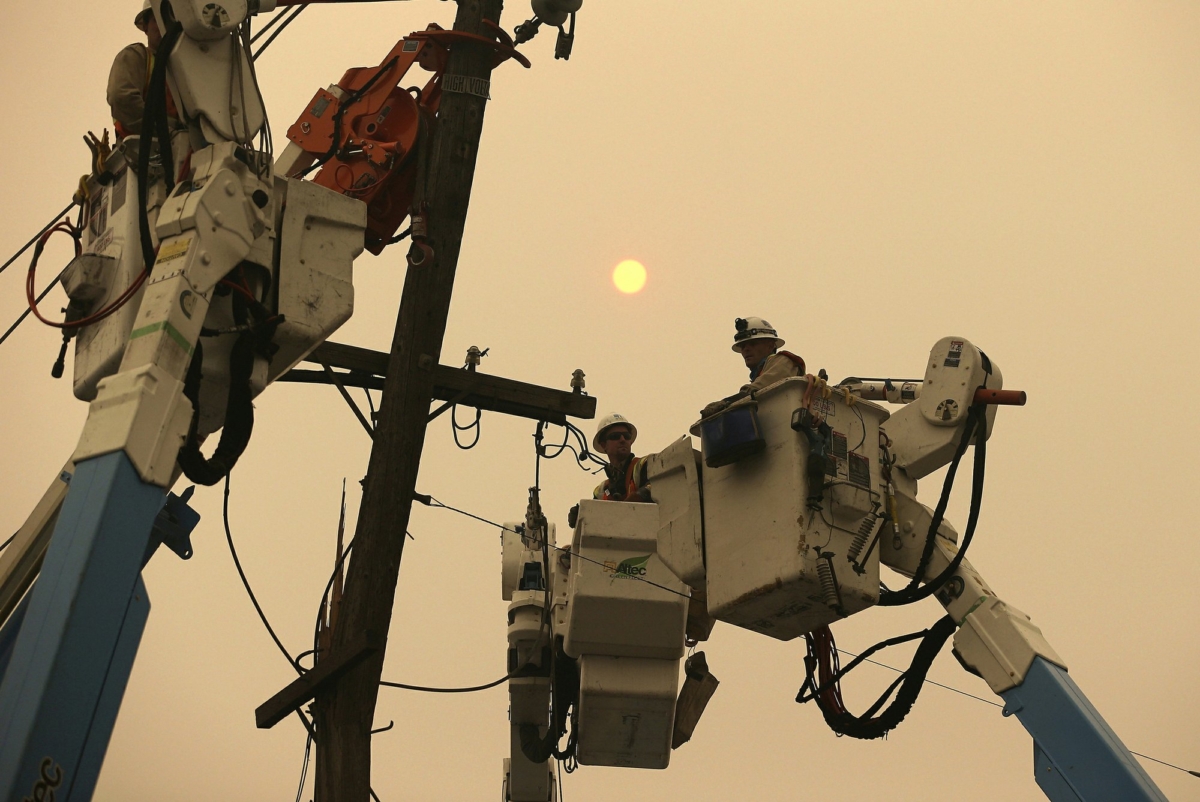 Pacific Gas & Electric crews work to restore power lines in Paradise, Calif., on Nov. 9, 2018. (Rich Pedroncelli/AP Photo)