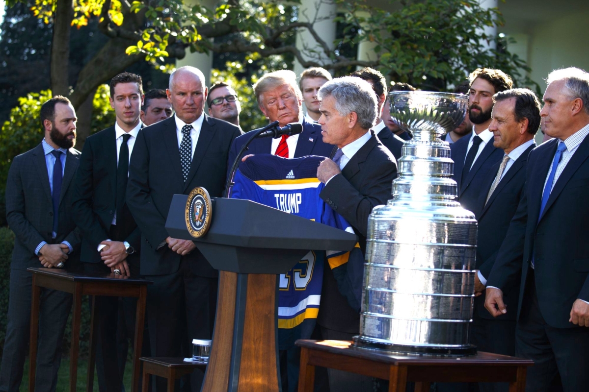 President Donald Trump is presented a team jersey by St. Louis Blues owner Tom Stillman during an event to honor the 2019 Stanley Cup Champion St. Louis Blues, in the Rose Garden of the White House, on Oct. 15, 2019. (Evan Vucci/AP Photo)