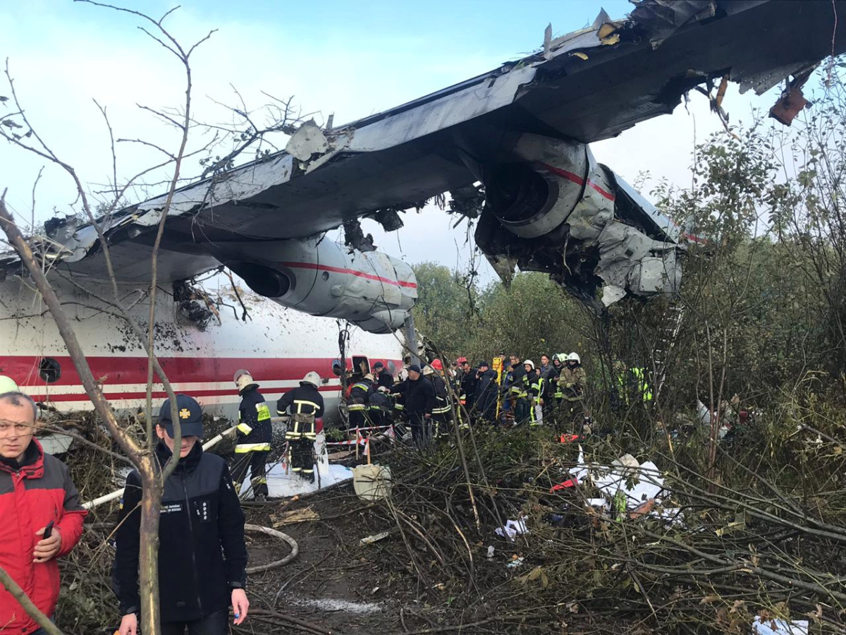 Members of emergency services work at the site of the Antonov-12 cargo airplane emergency landing in Lviv region, Ukraine on Oct. 4, 2019. (Lviv Mayor's Office/Handout via Reuters)