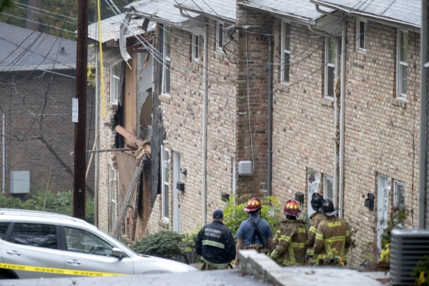 Fire officials look at the scene where an airplane crashed into an apartment complex in Atlanta on Oct. 30, 2019. (David Goldman/AP Photo)