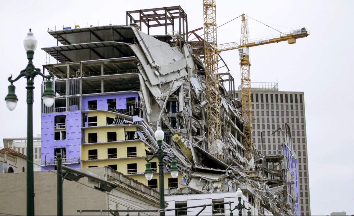Debris hangs on the side of the building after a large portion of a hotel under construction suddenly collapsed in New Orleans, La., on Oct. 12, 2019. (Scott Threlkeld/The Advocate via AP)