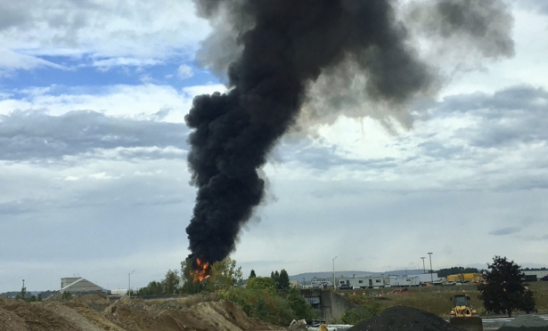 Smoke fills the sky after a World War II-era bomber plane crashed, outside Bradley International Airport north of Hartford, Conn. on Oct. 2, 2019. (Antonio Arreguin via AP)