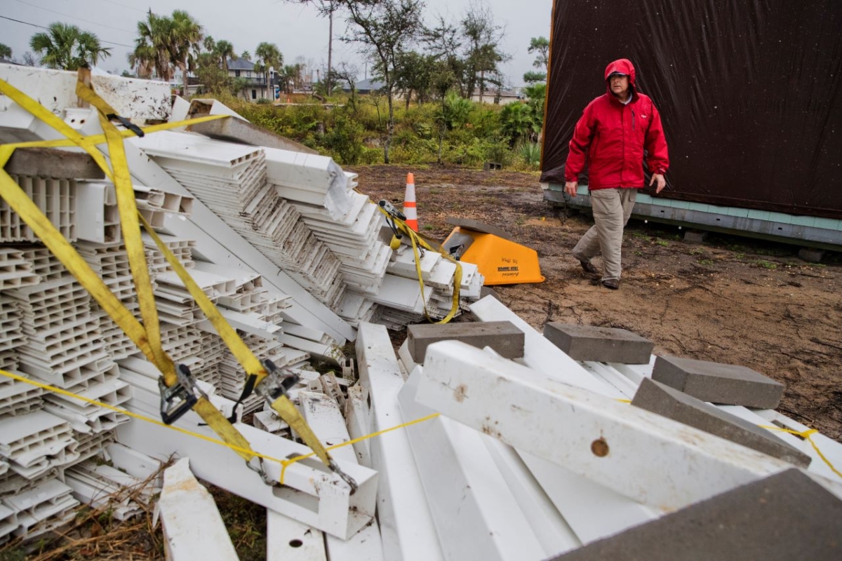Chris Anderson ties down building materials and other objects from his lawn as Tropical Storm Nestor approaches, in Mexico Beach, Fla., on Oct. 18, 2019. (Joshua Boucher/News Herald via AP)