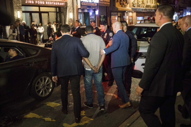 Police officers escort Randy Rodriguez Santos from the 5th Precinct to a vehicle bound for a hospital for evidence collection, in New York City on Oct. 5, 2019. (Julius Constantine Motal/(AP Photo)