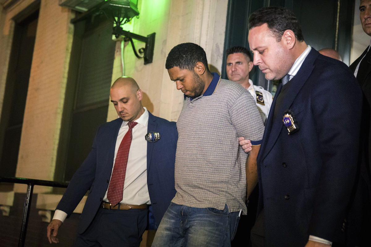 Police officers escort Randy Rodriguez Santos from the 5th Precinct to a vehicle bound for a hospital for evidence collection, in New York City on Oct. 5, 2019. (Julius Constantine Motal/AP)