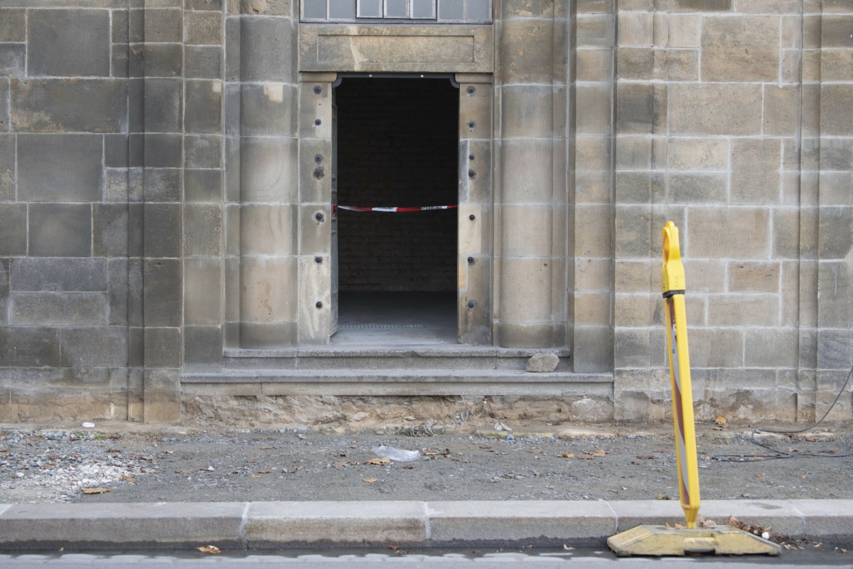 A caution tape is fixed at the entrance to catacombs under the August Bridge, where a fire destroyed the power supply for the State Art Collection with the Green Vault in Dresden, Germany on Nov. 25, 2019. (Sebastian Kahnert/dpa via AP)