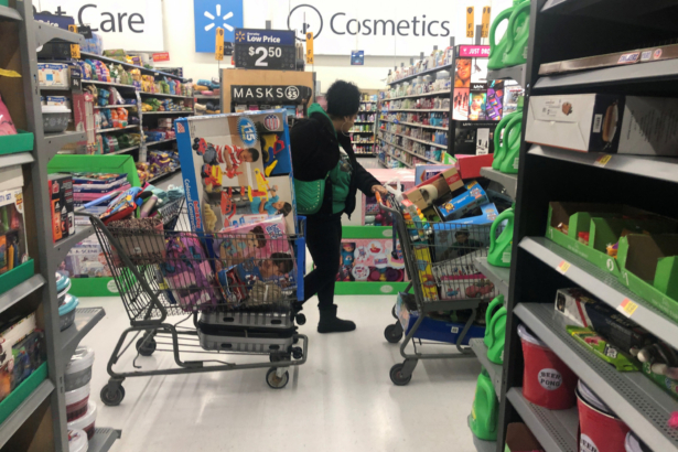 A woman pushes shopping carts during a sales event on Thanksgiving day at Walmart in Westbury, N.Y., on Nov. 28, 2019. (Shannon Stapleton/Reuters)
