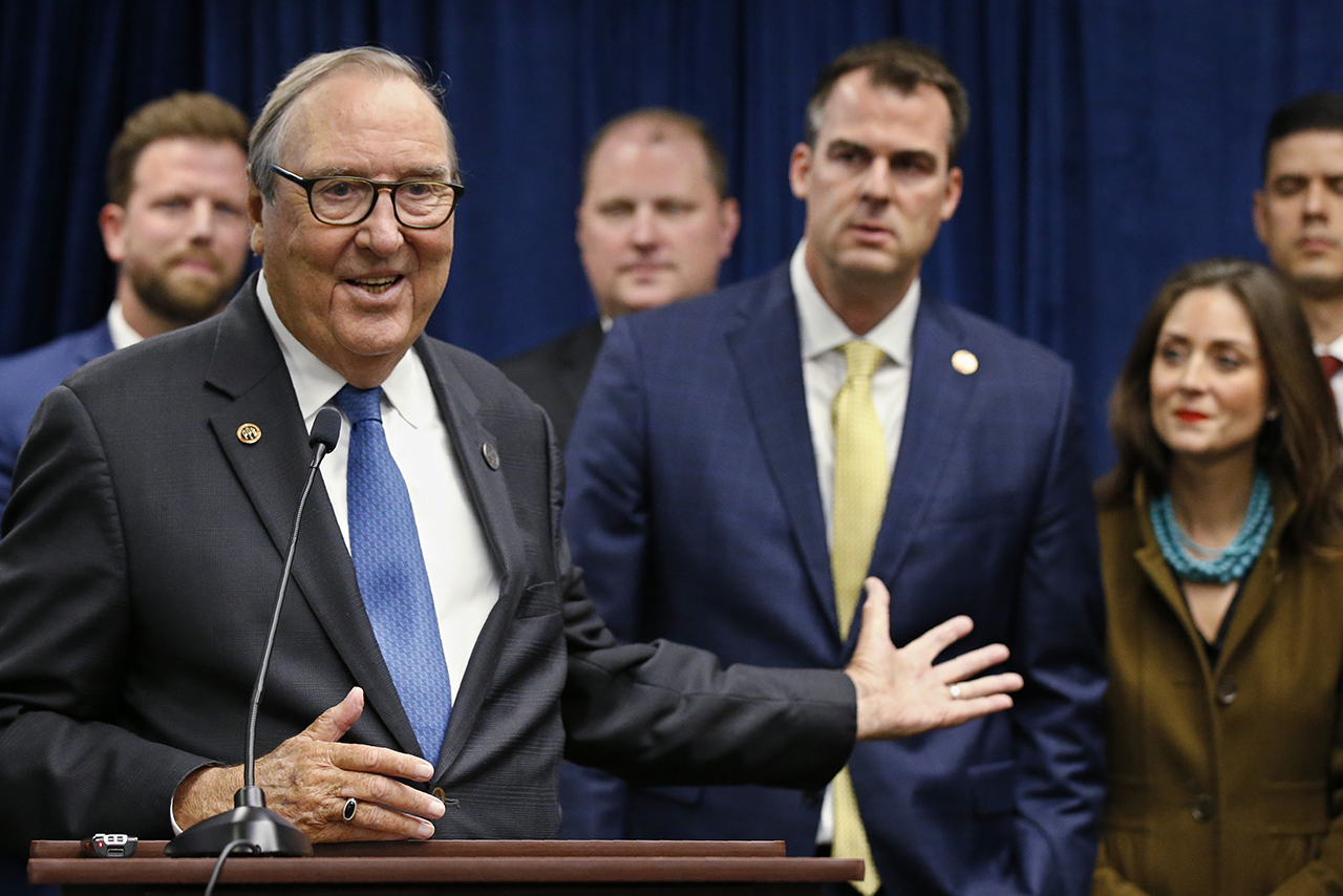 (L) Robert Gilliland, Oklahoma Pardon and Parole Board member, speaks during a news conference to announce that Oklahoma will release over 400 inmates after the board approved what they say is the largest single-day mass commutation in U.S. history. At right are Oklahoma Gov. Kevin Stitt and First Lady Sarah Stitt, in Oklahoma City, Okla., on Nov. 1, 2019.  (AP Photo/Sue Ogrocki)