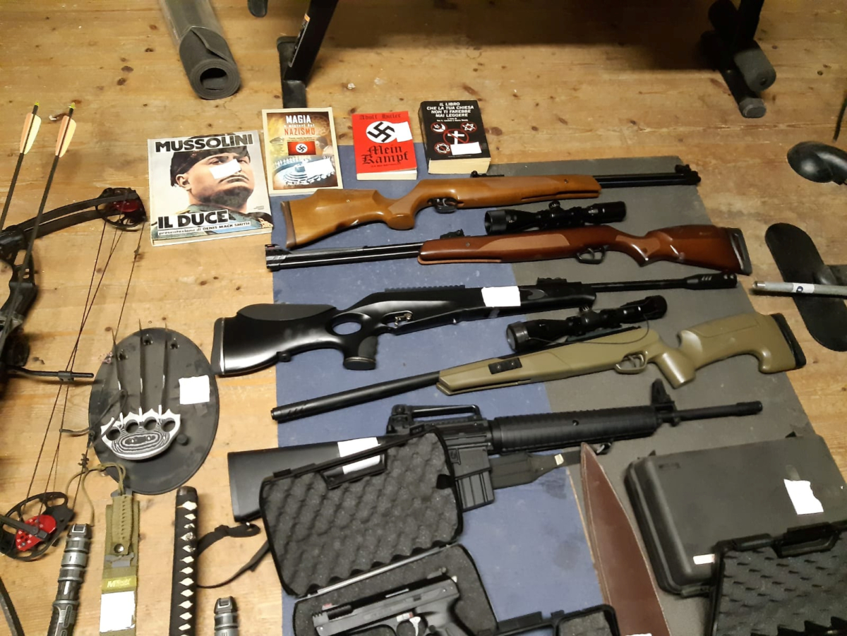 Italian police handout shows weapons including automatic rifles that they say were seized in searches of properties of an extreme political group who planned to create a new Nazi party, in an unidentified location in Italy a picture released on Nov. 28, 2019. (Polizia di Stato/Handout via REUTERS)