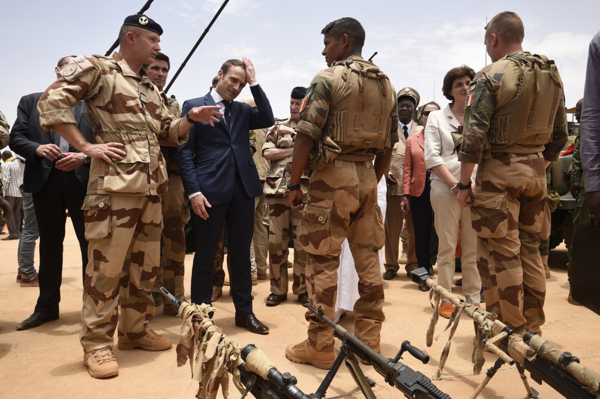 French President Emmanuel Macron, center left, visits soldiers of Operation Barkhane, France's largest overseas military operation, in Gao, Northern Mali, on May 19, 2017. (Christophe Petit Tesson, Pool via AP)