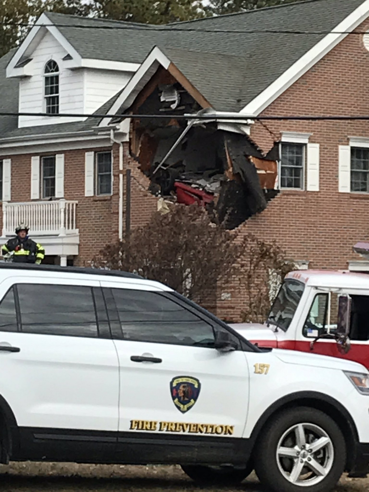 A red Porsche crashes into the second floor of a building in New Jersey on Nov. 10. (Courtesy of @jerzsteve/Twitter)