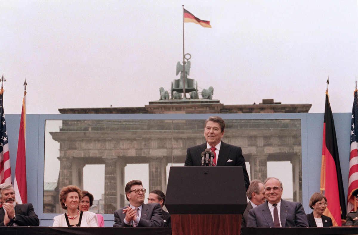 President Ronald Reagan, commemorating the 750th anniversary of Berlin, addresses the people of West Berlin at the base of the Brandenburg Gate, near the Berlin wall on June 12, 1987. (Mike Sargent/AFP via Getty Images)