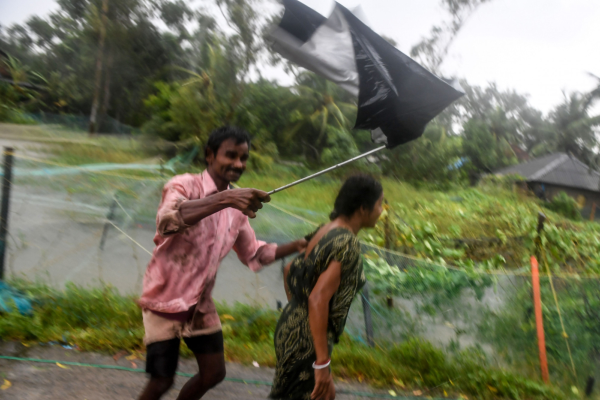 Villagers struggle against strong winds to enter a relief centre as Cyclone Bulbul is approaching, in Bakkhali near Namkhana in Indian state of West Bengal on Nov. 9, 2019. (Photo by Dibyangshu Sarkar/AFP via Getty Images)