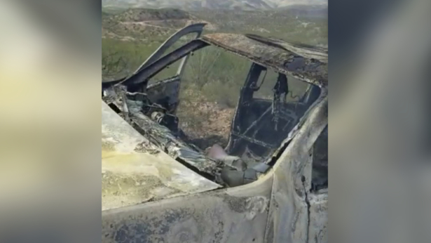 The burnt wreckage of a vehicle transporting a family living near the border with the United States after the family was caught in a crossfire between unknown shooters from rival cartels in Bavispe, Sonora, Mexico, on Nov. 4, 2019. (Kenny Miller/Courtesy of Alex LeBaron via AP)