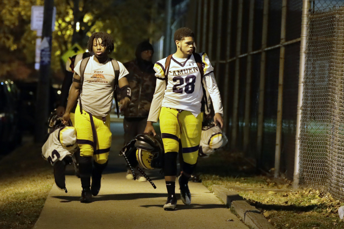 Camden High School football players walk down Park Blvd. in Camden, N.J., as they head back to their football field and locker room on Nov. 15, 2019. (Elizabeth Robertson/The Philadelphia Inquirer via AP)