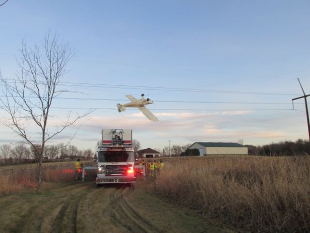Authorities arrived at the scene to help rescue the pilot from the power lines. (Scott County Sheriff's Office)