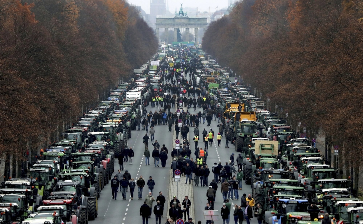 Farmers have parked their tractors on the 'Road of June 17' in front of the Brandenburg Gate in Berlin, Germany, Tuesday, Nov. 26, 2019. (AP Photo/Michael Sohn)