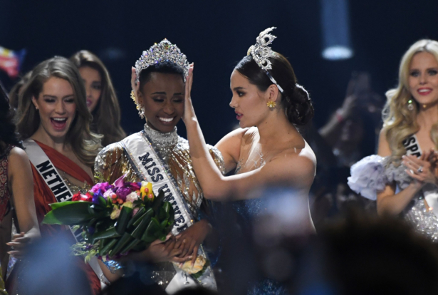 Miss Universe 2018 Philippines' Catriona Gray (R) crowns the new Miss Universe 2019 South Africa's Zozibini Tunzi on stage during the 2019 Miss Universe pageant at the Tyler Perry Studios in Atlanta, Ga., on Dec. 8, 2019. (Valerie Macon/AFP via Getty Images)