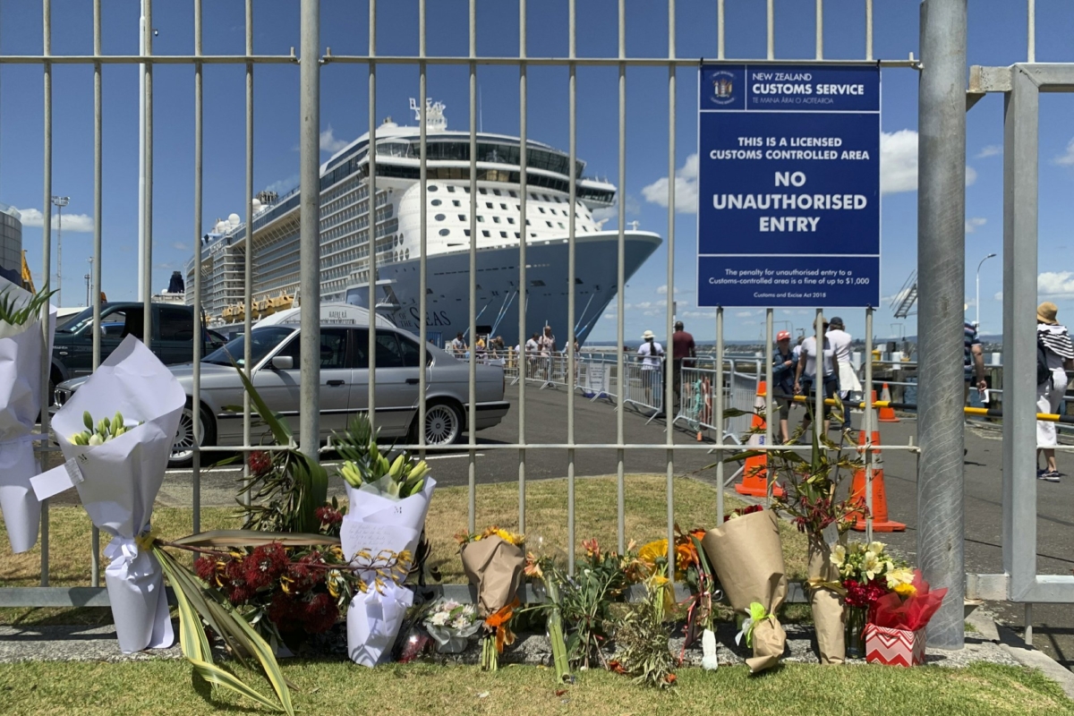 Flowers are laid on makeshift memorial is seen in front of cruise ship Ovation of the Seas, in Tauranga, New Zealand on Dec. 10, 2019. (Nick Perry/AP Photo)