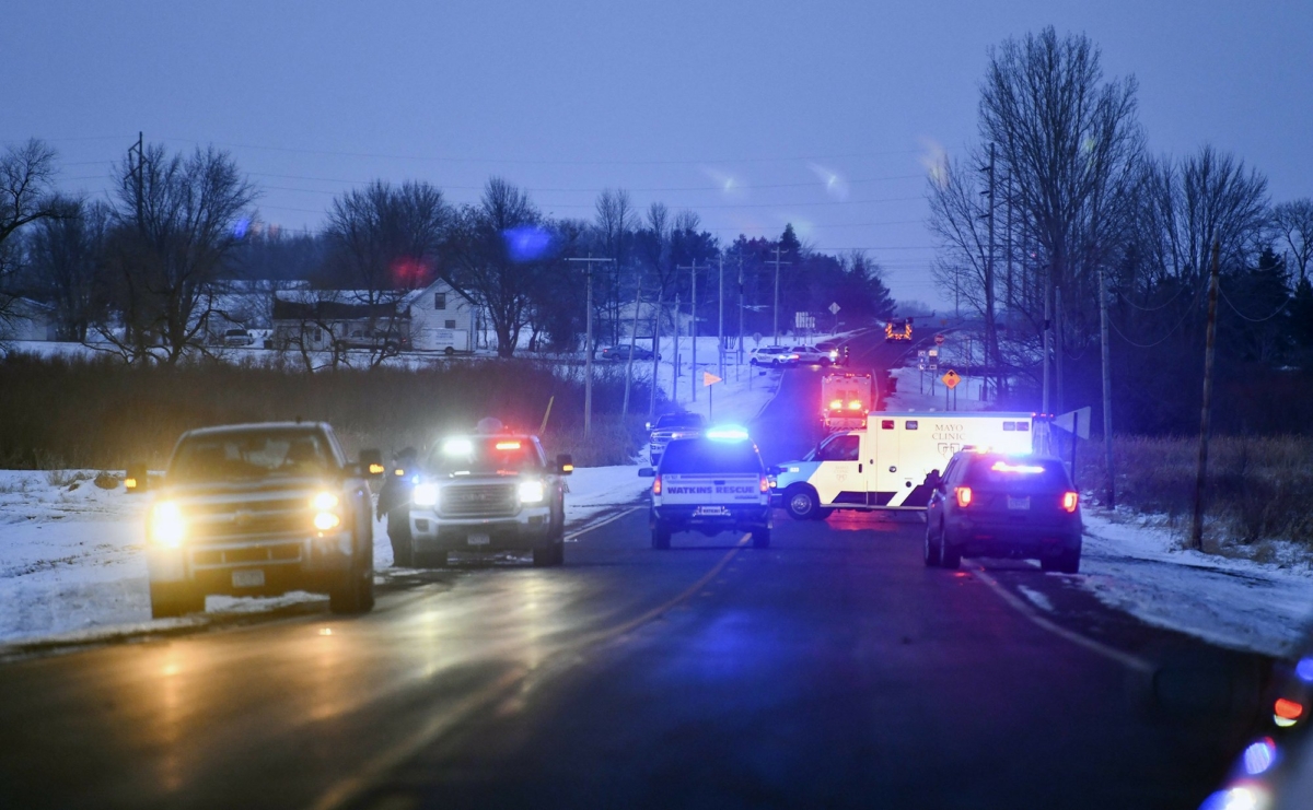 Emergency vehicles line the road near the scene of a helicopter crash on Dec. 5, 2019, near Marty, Minn. (Dave Schwarz/St. Cloud Times via AP)