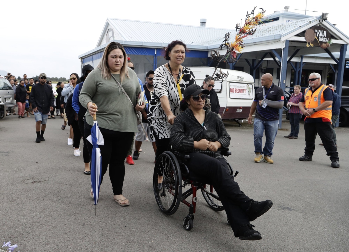Families of victims of the White Island eruption walk to a nearby marae after arriving back to the Whakatane wharf following a blessing at sea ahead of the recovery operation off the coast of Whakatane New Zealand on Dec. 13, 2019. (Mark Baker/AP Photo)