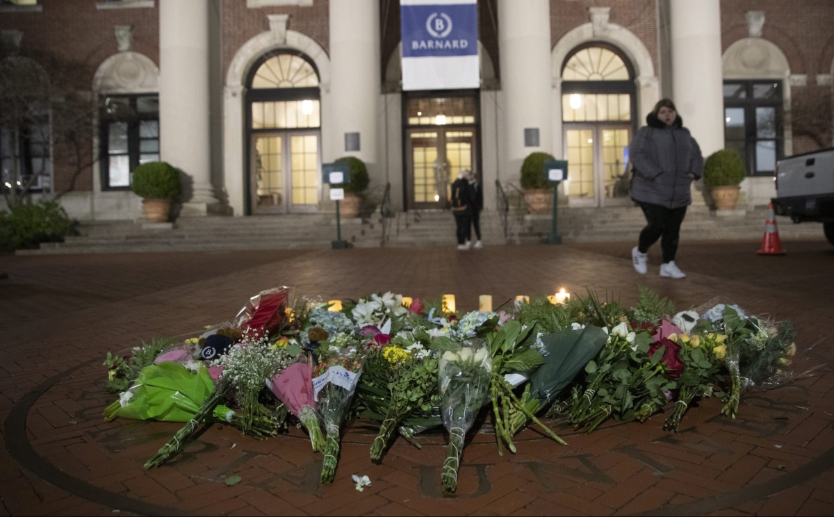 A woman walks past a makeshift memorial for Tessa Majors inside the Barnard campus in New York City on December 12, 2019. (Mary Altaffer/AP)