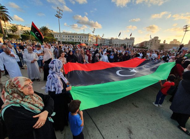 Libyans march with a giant national flag during a demonstration in support of the Tripoli-based UN-recognised government and against strongman Khalifa Haftar in the capital Martyrs Square on September 27, 2019 (Mahmud Turkia/AFP/Getty Images)