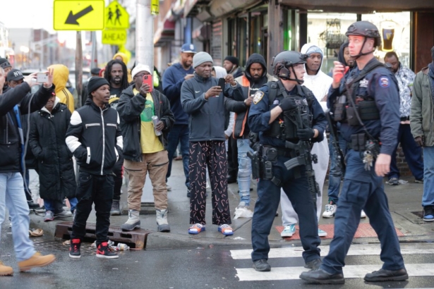 Bystanders look on as law enforcement arrive on the scene following reports of shooting,