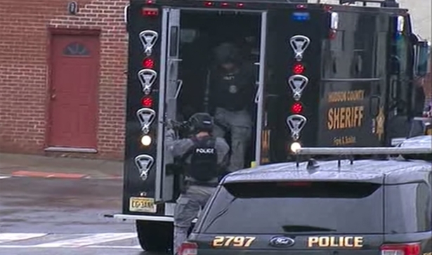 Hudson County Swat team officers arrive at the scene following reports of gunfire in Jersey City, N.J., on Dec. 10, 2019. (WNYW FOX 5 via AP)