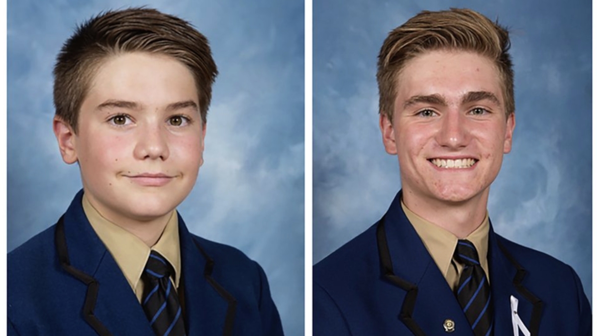In this undated photo provided by his family/Knox Grammar School, Matthew Hollander (L), and Berend Hollander (R) pose for a class photo in Sydney, Australia. The teens died in a hospital from injuries after a volcano erupted near Whakatane, New Zealand on Dec. 9, 2019. (Family/Knox Grammar School via AP)