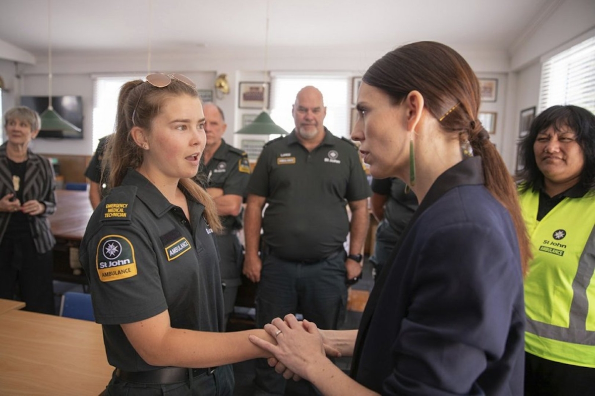 New Zealand's Prime Minister Jacinda Ardern, right, talks with first responders in Whakatane, New Zealand on Dec. 10, 2019. (Dom Thomas/Pool Photo via AP)