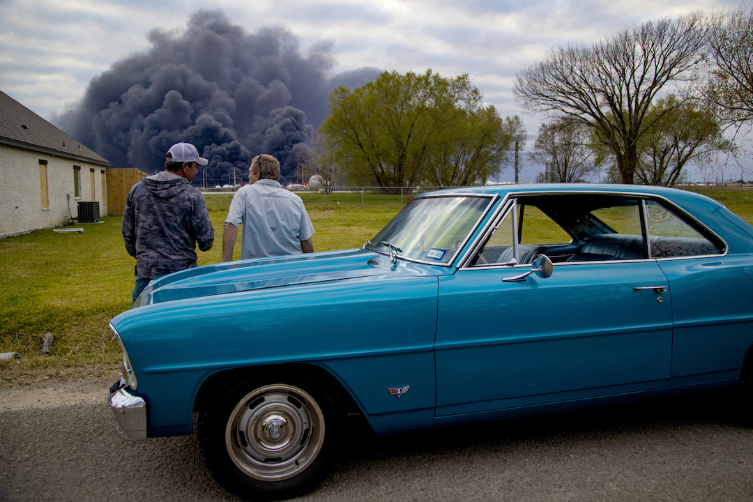 Ray Moore and Milton Perio observe the fire consuming TPC Group plant in Port Neches, Texas, on Nov. 27, 2019. (Marie D. De Jesús/Houston Chronicle via AP)