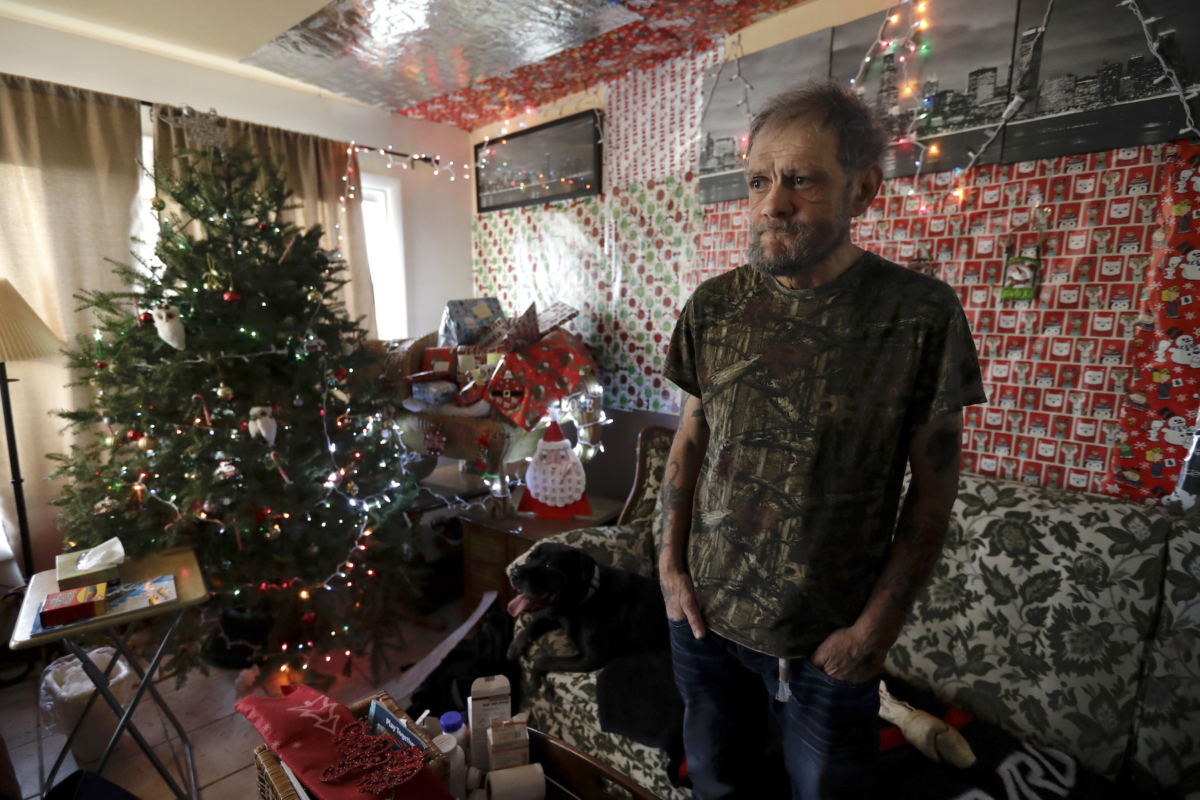 Bobby Goldberg stands in the living room at his home in suburban Chicago, on Dec. 20, 2019. (AP Photo/Nam Y. Huh)