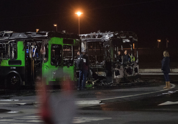 Investigators work at the scene of a fire, that destroyed two passenger buses and damaged a third, at Los Angeles International Airport, Calif., on Dec. 21, 2019. (Mark Ralston/AFP via Getty Images)