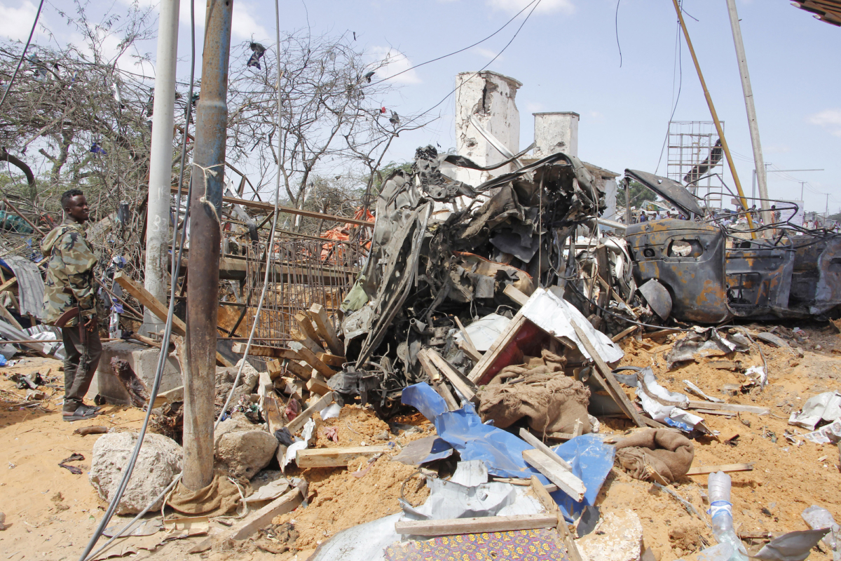 Soldier stand guard near wreckage of vehicles in Mogadishu after car bomb in Mogadishu, Somalia, on Dec, 28, 2019. (Farah Abdi Warsame/AP Photo)