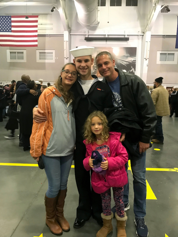 Cameron Walters, center in Navy uniform, poses for a photo with his sisters, Lily Walters, left, and Shania Walters, right, and his father, Shane Walters,