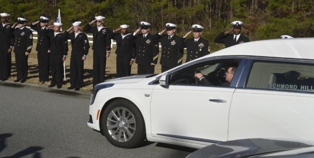 Sailors salute as the hearse carrying Cameron Walters arrives at Oak Hill Cemetery