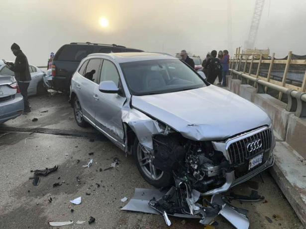 Drivers stand at the scene of a multi-vehicle pileup on Interstate 64 in York County, Va., Sunday, Dec. 22, 2019. (Ivan Levy via AP)