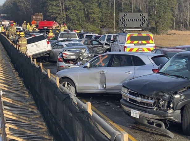 In this photo provided by the Virginia State Police, emergency personnel work the scene of a multi-vehicle pileup on Interstate 64 in York County, Va., on Dec. 22, 2019. (Virginia State Police via AP)