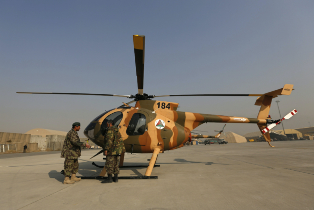 Members of the Afghan Air Force crew stand next to a helicopter at the military airport in Kabul on Dec. 18, 2014. (Mohammad Ismail/Reuters-File)
