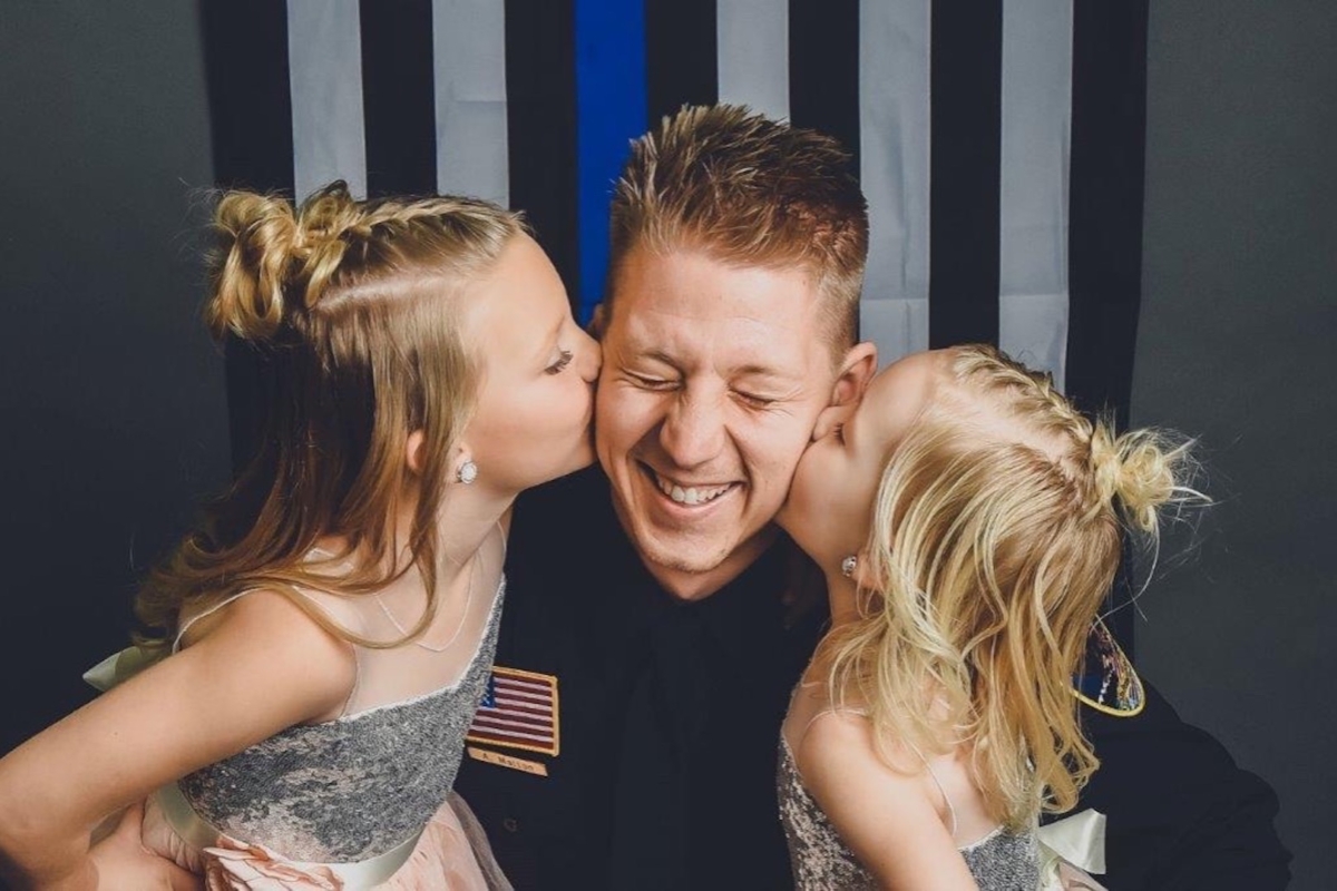 Southern Minnesota officer Arik Matson (C) with his two daughters. (Arik Matson Family/GoFundMe)
