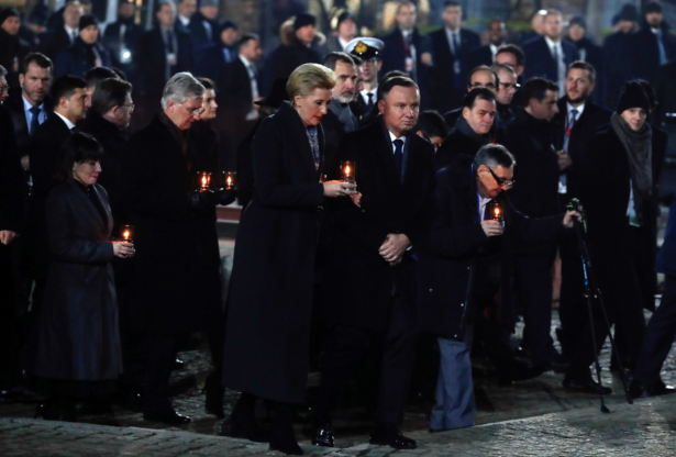 Poland's President Andrzej Duda and his wife Agata Kornhauser-Duda, Holocaust survivor Marian Turski, King Philippe of Belgium, King Felipe of Spain walk with candles to light them at the Monument to the Victims at the former Nazi German concentration and extermination camp Auschwitz II-Birkenau, during ceremonies marking the 75th anniversary of the liberation of the camp and International Holocaust Victims Remembrance Day, in Brzezinka near Oswiecim, Poland, on Jan. 27, 2020. (Aleksandra Szmigiel/Reuters)