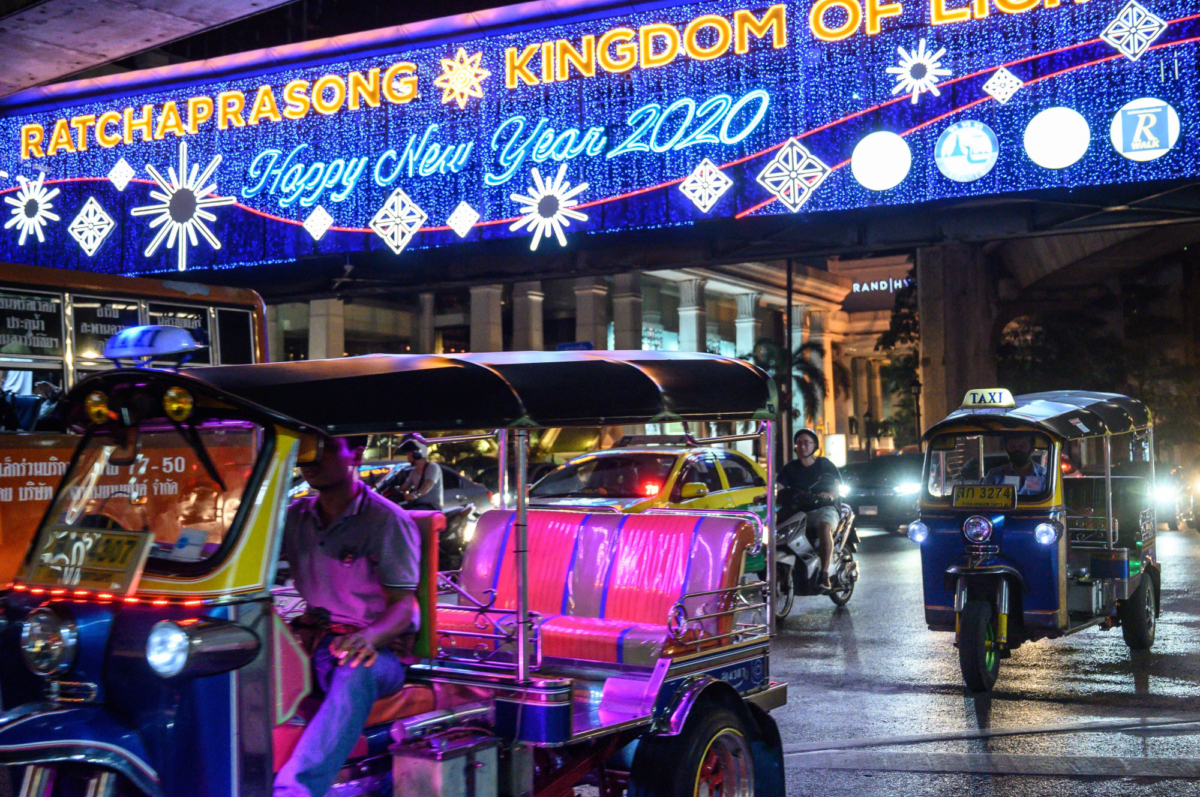 Commuters pass under a sign reading 'Happy New Year 2020' in downtown Bangkok on Dec. 27, 2019. (Mladen Antonov//AFP via Getty Images)