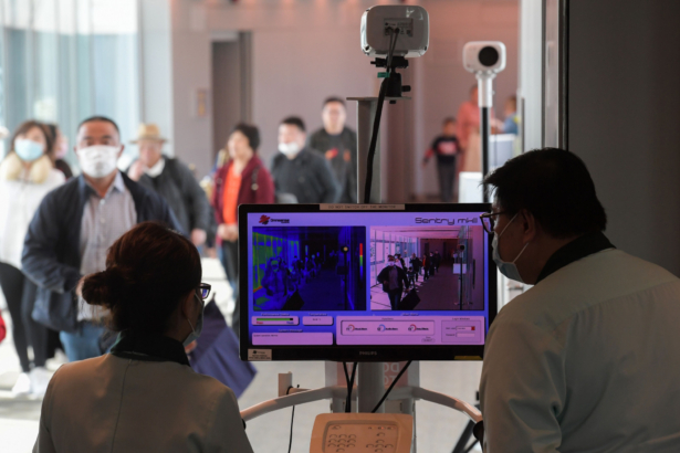 Health officers screen arriving passengers from China with thermal scanners at Changi International airport in Singapore on Jan. 22, 2020. (Roslan Rahman/AFP via Getty Images)