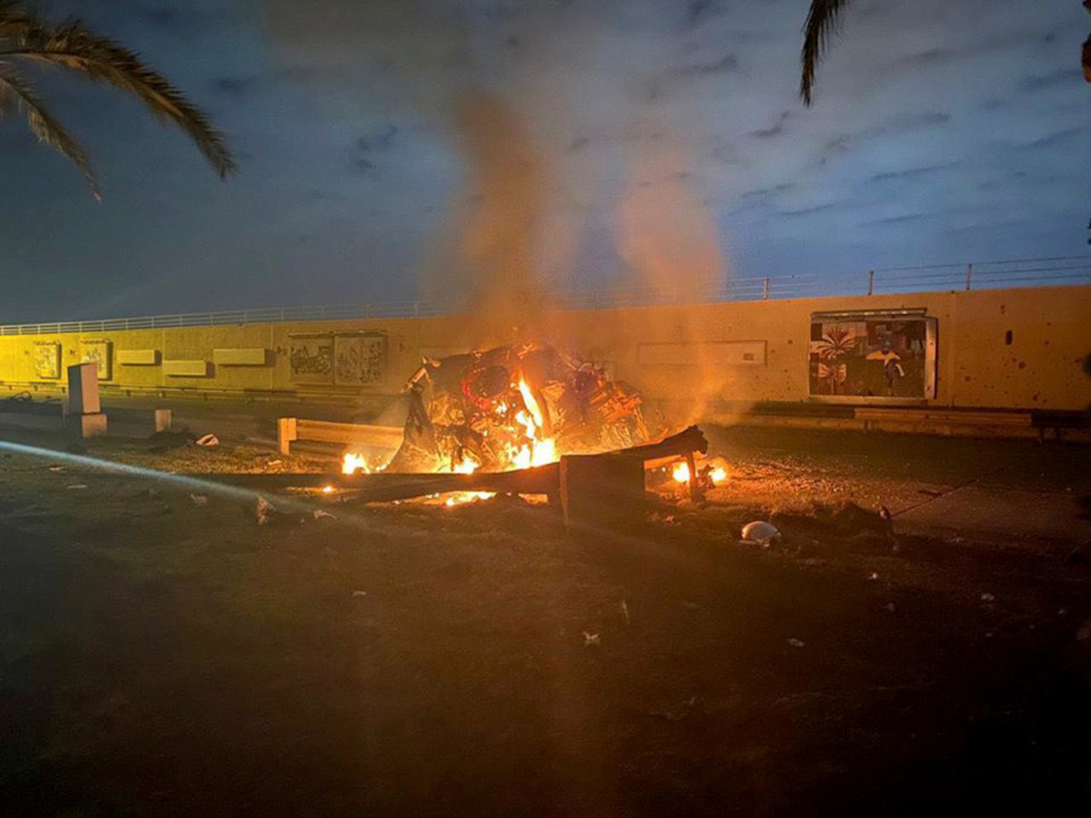 A burning vehicle at the Baghdad International Airport following an airstrike, in Baghdad, Iraq, on Jan. 2, 2020. (HO, Iraqi Prime Minister Press Office, via AP)