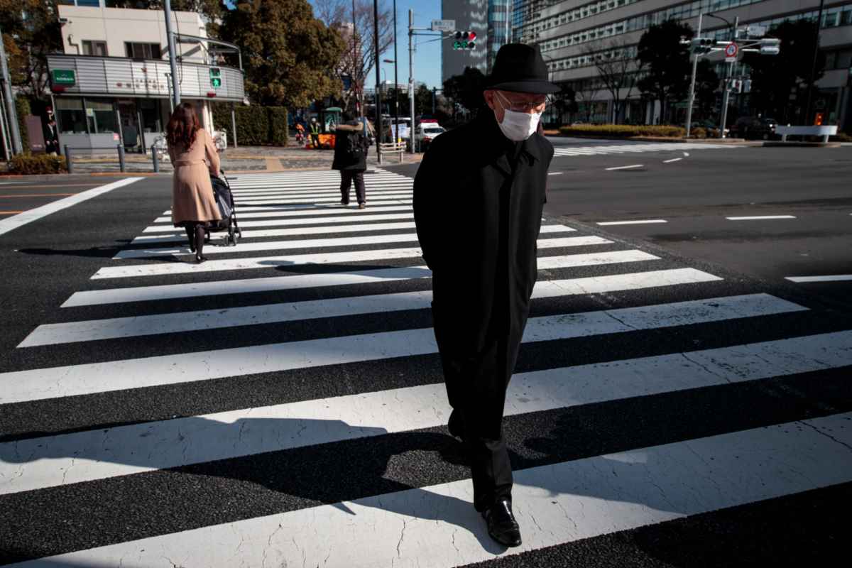 An elderly man wearing a protective mask crosses a street in Tokyo on Jan. 29, 2020. (BEHROUZ MEHRI/AFP via Getty Images)