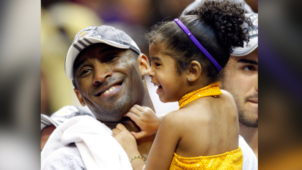 Kobe Bryant #24 of the Los Angeles Lakers holds his daughter, Gianna, after the Lakers defeated the Orlando Magic 99-86 in Game Five of the 2009 NBA Finals at Amway Arena in Orlando, Fla., on June 14, 2009. (Ronald Martinez/Getty Images)