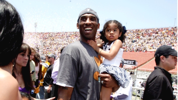 Los Angeles Lakers' Kobe Bryant smiles as he carries his daughter, Gianna Maria-Onore, up the steps after the victory parade celebrating the Lakers' NBA championship in Los Angeles, Calif., on June 17, 2009. (Jae C. Hong/AP Photo)